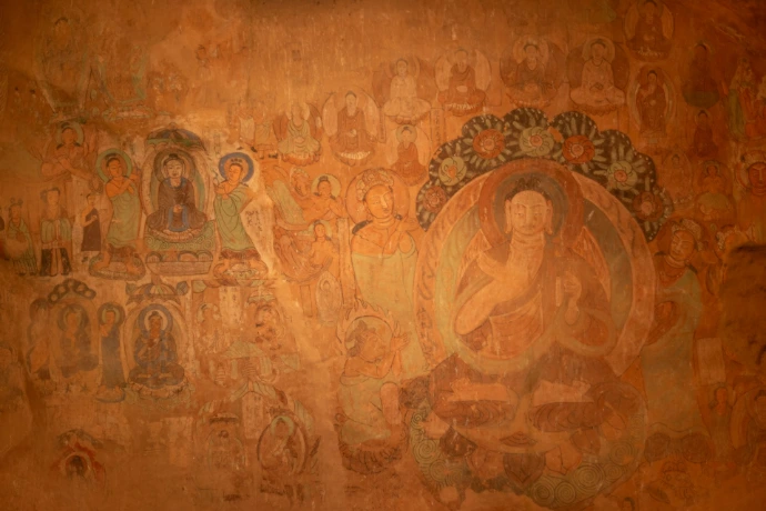 Buddhist mural paintings adorn an ancient wall.